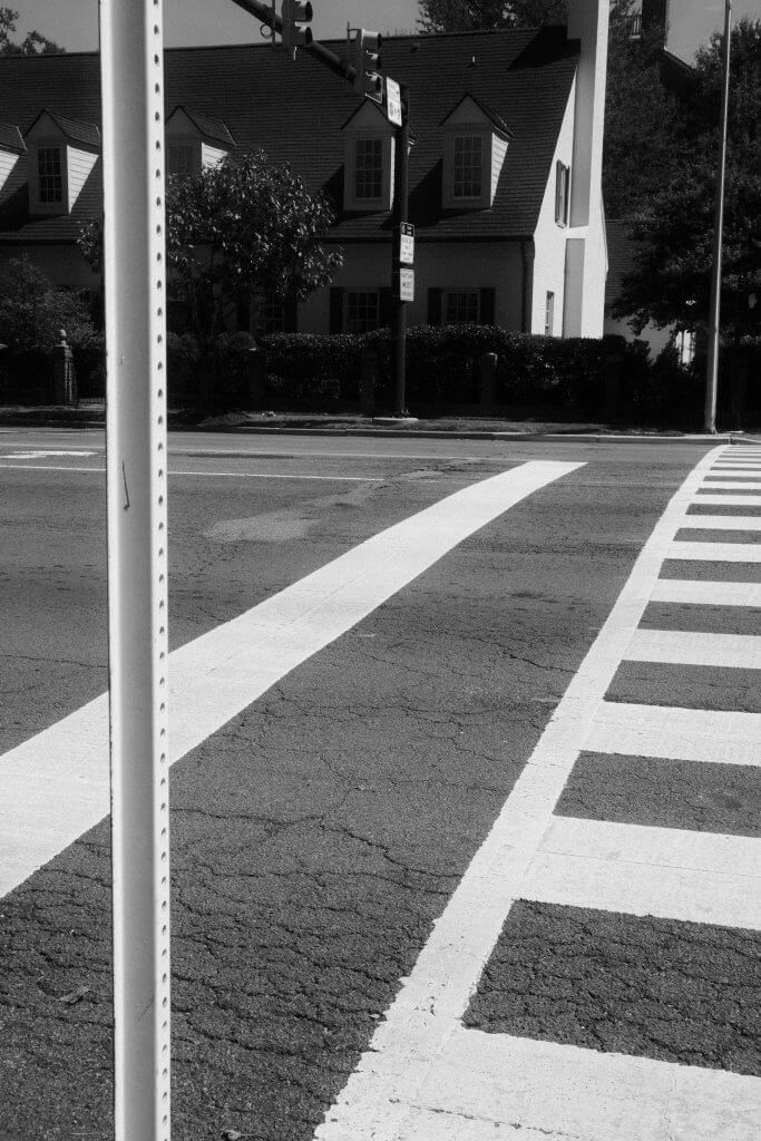 A pedestrian crossing and an adjoining signpost.