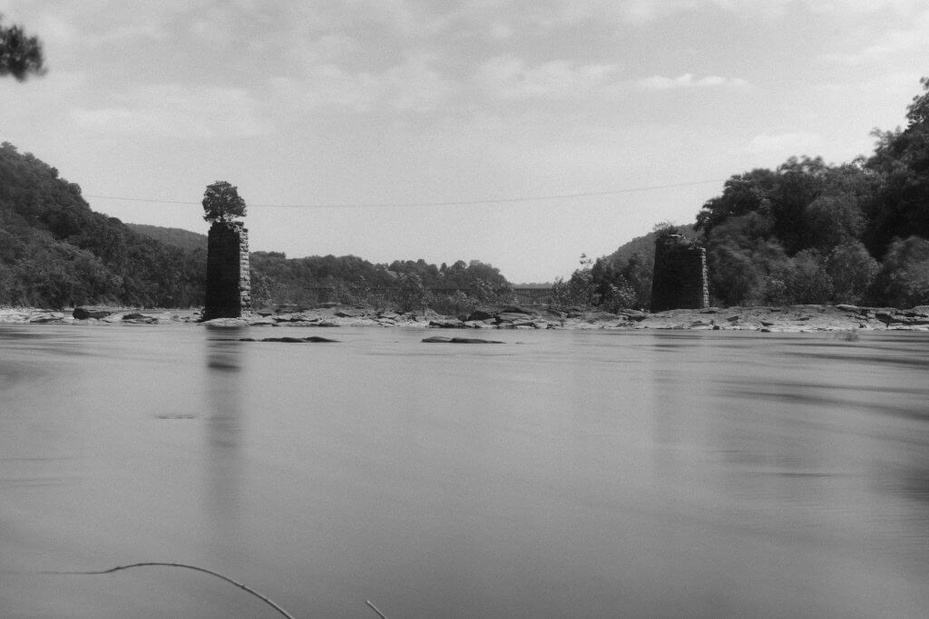 The Shenandoah River flowing between two large stone towers.