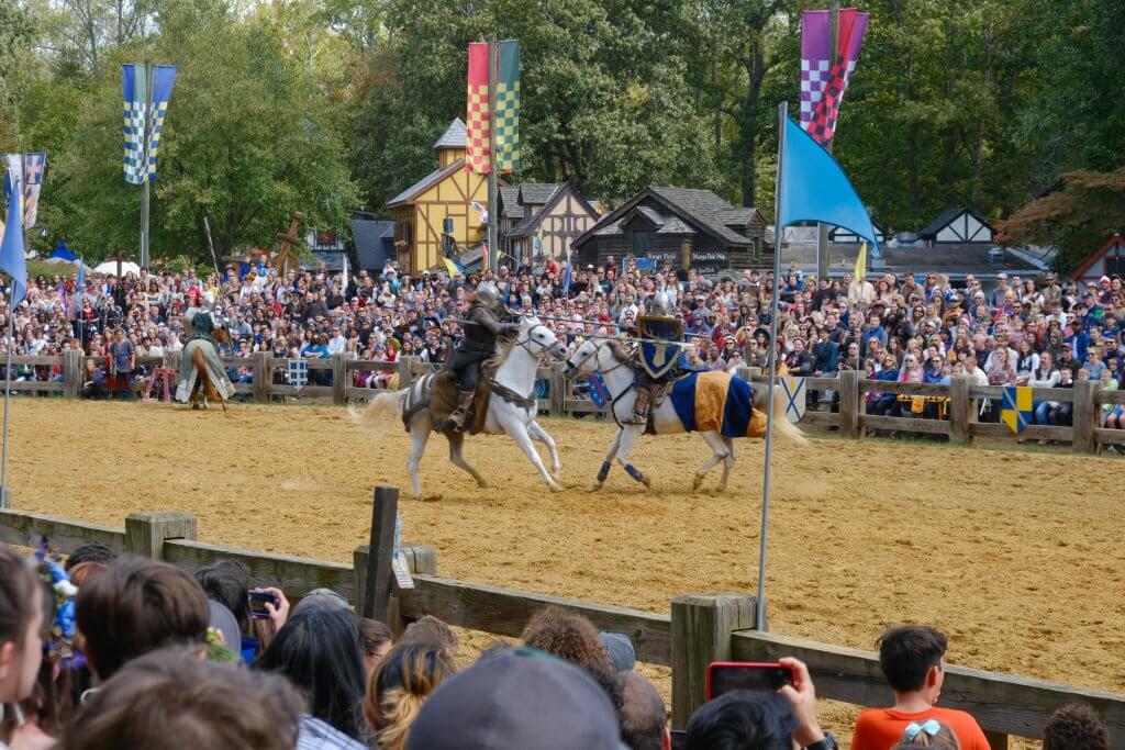 Two knights on horseback, jousting.